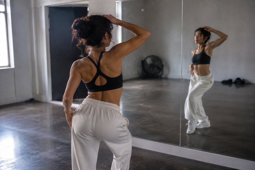 A dancer rehearsing in a mirrored studio